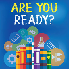 Text sign showing Are You Ready Question. Business photo text used telling someone start something when feel prepared Books Arranged Standing Up in Row with Assorted Educational Icons Behind