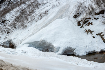 Fototapeta na wymiar avalanche on the mountain river Gonachkhir in Dombay, Karachay-Cherkessia, Russia