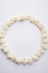Jasminum sambac or Mogra Flower arranged in a  circular or rectangular  frame shape over white background, selective focus