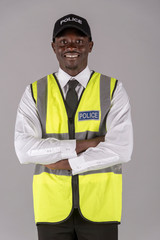 Salisbury, Wiltshire, UK. April 2019. Portrait of a smiling police officer in uniform with arms folded