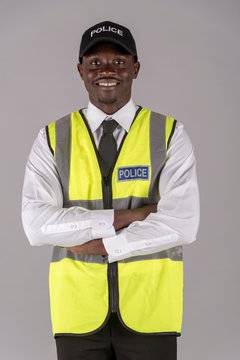Salisbury, Wiltshire, UK. April 2019. Portrait of a smiling police officer in uniform with arms folded
