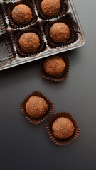 chocolate petit fours over black background. Top view.