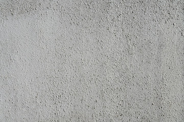Plain gray textured plastered wall. Rough textured background of wall with copy space for text