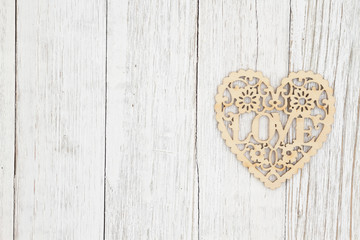 Wood heart on weathered whitewash textured wood background