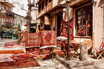 Sale of national carpets on the streets of Tbilisi. Georgia. - obrazy, fototapety, plakaty