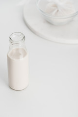 selective focus of rice milk in bottle with rice in cheesecloth on background