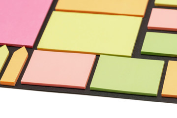 Blank note paper set of different colours forms and sizes. Sticky notes collection on black background