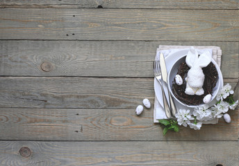 Table setting for happy Easter in rustic style.
