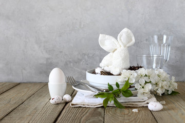 Table setting for happy Easter in rustic style.