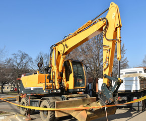 Excavator at the road construction