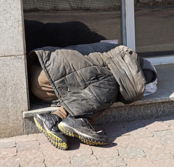 Homeless man sleeps on the street