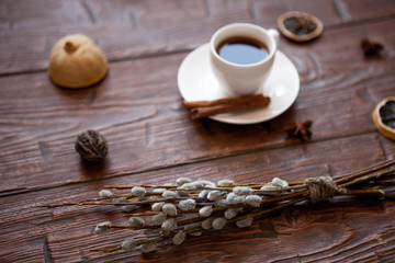 Coffee cup and willow branches, dry lemon, cinnamon.