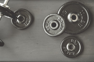 Obraz premium dumbbell and barbell on floor at gym