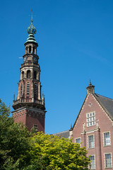 tower of town hall in Leiden, with trees, against blue sky, The Netherlands. Copy space