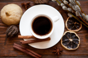 Coffee cup and willow branches, dry lemon, cinnamon.