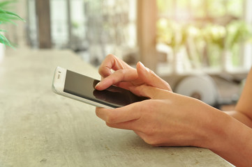 people using mobile phone at gym