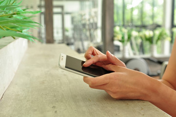 people using mobile phone at gym