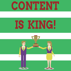 Writing note showing Content Is King. Business concept for marketing focused growing visibility non paid search results Man and Woman Business Suit Holding Championship Trophy Cup