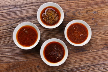 spices in spoons on wooden background