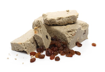 Halvah with raisins and peanuts isolated on white background