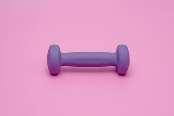 violet dumbbell for fitness  on pink background