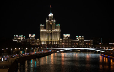Fototapeta premium Evening landscape.View from the bridge to the waterfront. Moscow river.Dark sky.Beautifully illuminated buildings.