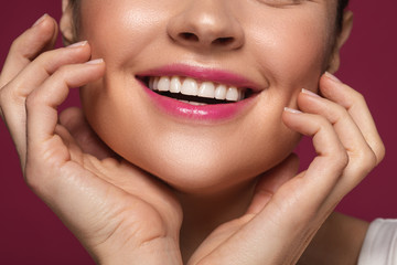 Happy woman smiling and touching face with two hands