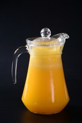 jug of juice and glass of orange juice
