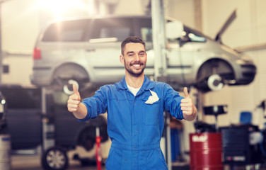 car service, repair, maintenance, gesture and people concept - happy smiling auto mechanic man or...