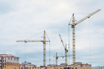 Fototapeta na wymiar construction cranes construction of houses