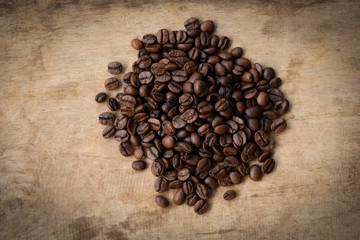 Coffee beans roasted on rustic wood background