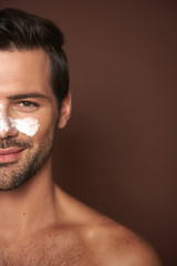 Young smiling manful guy with face mask