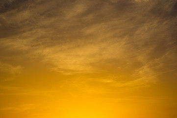 Landscape with dramatic light - beautiful golden sunset with saturated sky and clouds.