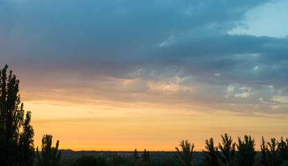 Obraz premium Landscape with dramatic light - beautiful golden sunset with saturated sky and clouds.