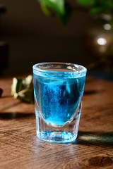 glass of water with ice on background