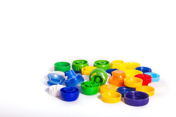 Plastic pollution. Some plastic caps isolated on white background