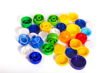 Plastic pollution. Some plastic caps isolated on white background