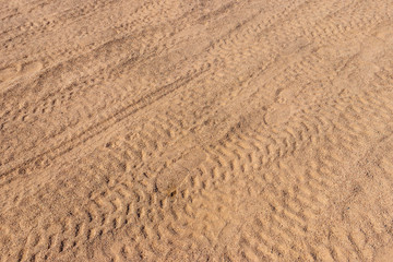 Tracks from tires on sand in desert