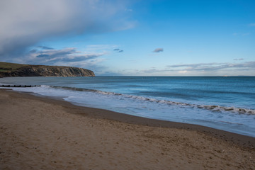 Fototapeta na wymiar Groins and sea surf on a pebble beach