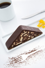 Cake slice, white porcelain coffee cup, white background, yellow  flowers, cacao, fork shaped, white table top, close up, macro shot