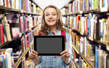 education, school and people concept - happy smiling teenage student girl with bag showing blank tablet computer screen over library background