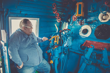 Cab in the old train locomotive in blue and red colors with manual control