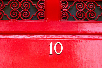 Bright red house door number 10 