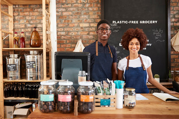 Portrait Of Male And Female Owners Of Sustainable Plastic Free Grocery Store
