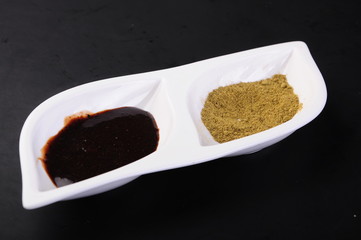 spices in spoons on white background