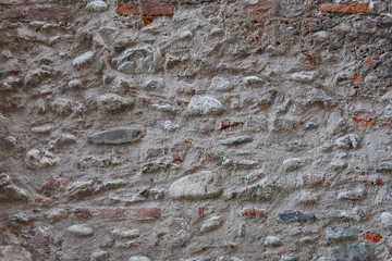 Stone wall background and ancient tuff, Tuscany in Italy