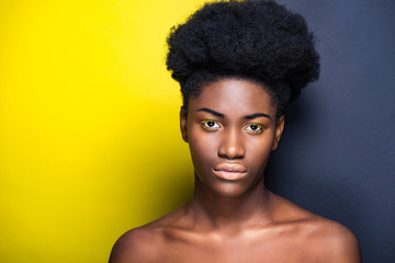 Front view of beautiful african american looking at camera on black and yellow