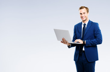 Businessman using laptop, isolated