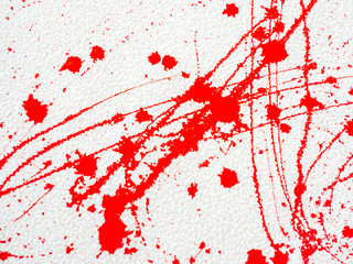 red blot and splatter paint on white background