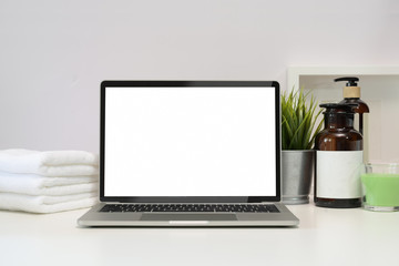 Fototapeta premium Blank screen laptop on spa table